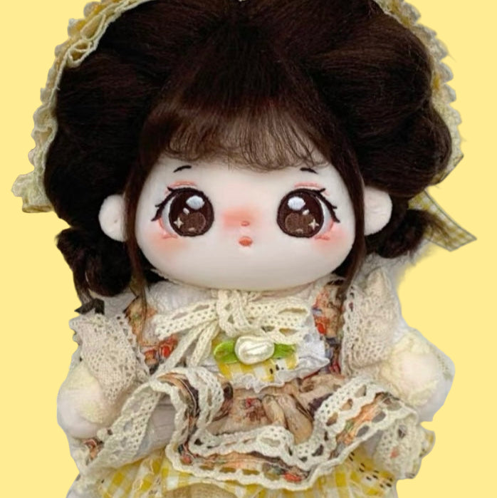 Small doll with a lace dress and floral headband on a white background