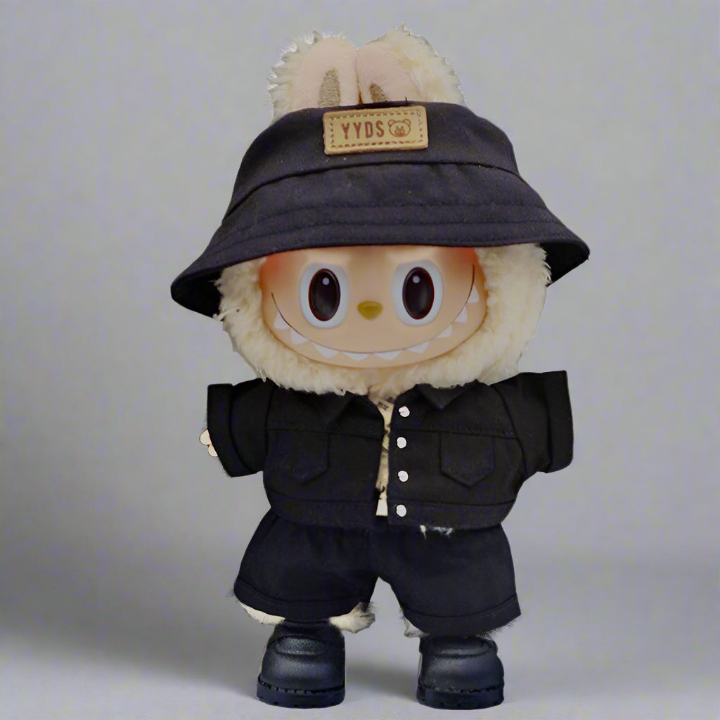 Plush toy with a black hat and coat on a neutral background