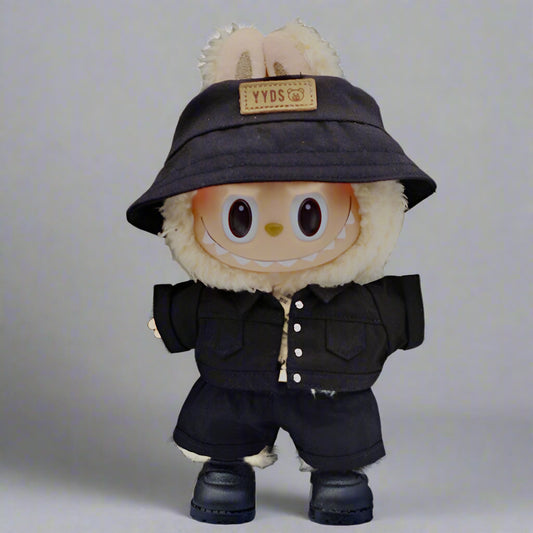 Plush toy with a black hat and coat on a neutral background