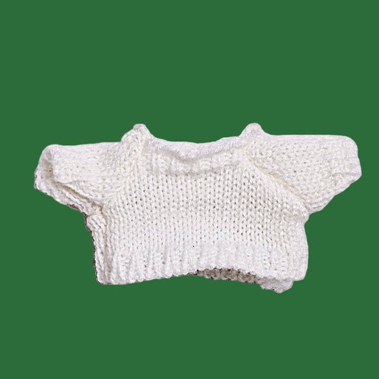 Knitted white crop top on a light purple background