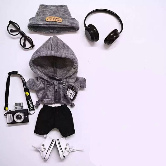 Collection of gray hoodies, sunglasses, headphones, camera, and shoes on a white background