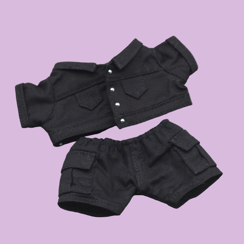 Black denim jacket and shorts set on a gray background