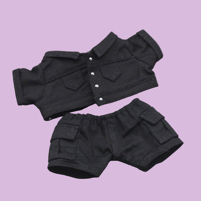 Black denim jacket and shorts set on a gray background